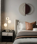 Three Light Brass Bedside Lamp With Mid Century Globe Shade In White And Gold For Reading In Office Living Room Dresser And Bathroom G9 Base Perfect Retro Modern Vibe And Cozy Nightstand Ambience in a bedroom setting