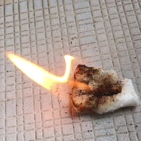 A lit fire starter tab demonstrating ignition on a tiled surface. 48 Pack Fire Starter Tabs Waterproof Tinder For Camping, Survival, And Campfire Ignition.