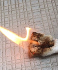 Emergency Fire Starter Tinder For Camping And Survival, Wax Coated Cotton Fire Tabs, 24 Pack, burning on a tiled surface