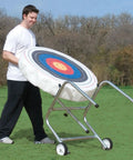 Person using Monster Archery Target Stand with Adjustable Frame that holds 30 to 50 inch targets, galvanized steel tubing outdoors