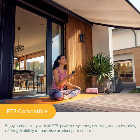 Person sitting on a porch using remote with Eolis 3D WireFree RTS Wind Sensor For Awnings, off white finish in home setting.