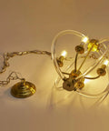 Modern Four Light Pendant Chandelier With Clear Acrylic Globes And Brass Finish In Dope Farmhouse Style showcasing glowing bulbs