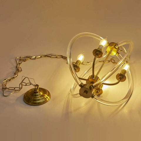 Modern Four Light Pendant Chandelier With Clear Acrylic Globes And Brass Finish In Dope Farmhouse Style showcasing glowing bulbs