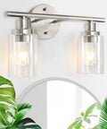 2 Light Wall Sconce Vanity Light in Brushed Nickel with Clear Glass Shades above bathroom mirror