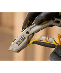 2 In 1 Snap Off Knife Xtreme with stainless steel blade guide, 9mm width, quick blade change via notched wheel, gray handle in use.