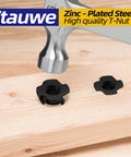 Hammer installing 5/16-18 Tee Nuts Four Pronged Black Zinc Plated Steel for wood and furniture projects on wooden surface