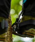 Climber wearing Steel Tree Climber Gaffs With Ergonomic Shank And 20 Plus Cuff Adjustment Points in use on tree trunk