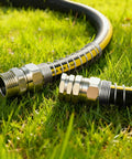 Solid Brass Five Eighths Inch Garden Hose Repair Kit With Spring Guard, heavy duty male and female ends on grass lawn