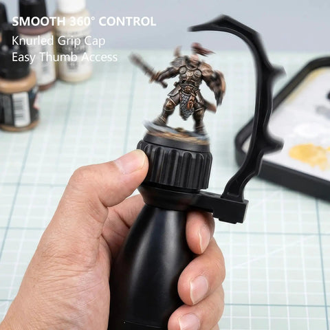 Precision Miniature Painting Handle With Stabilizer Bar And Magnetic Base held by hand showing 360 degree rotation with figure.