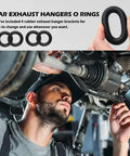 Mechanic holding Universal Exhaust Hangers Rubber Muffler Mounts 4 Pack For Cars, Trucks And SUVs under vehicle