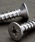 Top Shelf Gauge 4 By One Half Inch 304 Stainless Steel Wood Screws With A Smooth Phillips Drive And Deep Cut Fine Threads Built Tight For Heavy Duty Framing And Decking Projects Offering A Sweet Bang For Your Buck In A 100 Piece Pack, close-up showing heads and threads.
