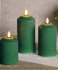 Green Christmas Flameless Pillar Candles With Remote Control Battery Powered Led Wax Candles Real Wax Look And Flicker Flames Cone Top Design With Lifelike Wicks 3 Pack For Cozy Holiday Vibes, shown in three different heights on a wooden shelf.