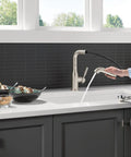 Straight Up Premium Brushed Nickel Kitchen Faucet With Sleek Pull Out Sprayer Single Handle Layout in use while rinsing dishes.