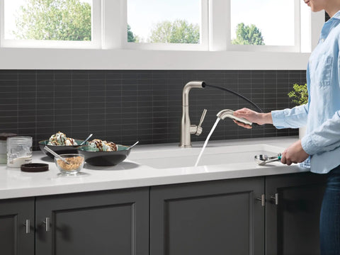 Straight Up Premium Brushed Nickel Kitchen Faucet With Sleek Pull Out Sprayer Single Handle Layout in use while rinsing dishes.