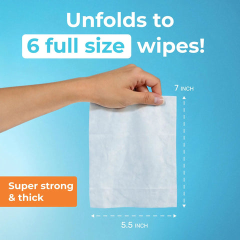 Hand holding a 7x5.5 inch wipe, from Ultra Compact Travel Flushable Wipes With 99.5 Percent Water And Aloe, showing size and thickness.