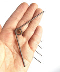 Hand holding 5 Pack V Shape Long Reach Pruner Handle Replacement Springs Torsion Kit For Pruning Shears Pro Grade Thick And Strong.