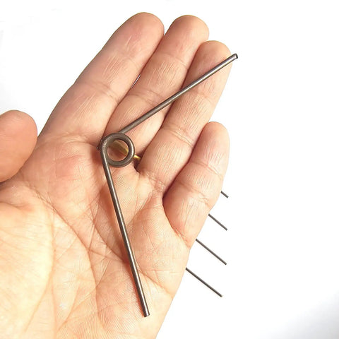 Hand holding 5 Pack V Shape Long Reach Pruner Handle Replacement Springs Torsion Kit For Pruning Shears Pro Grade Thick And Strong.