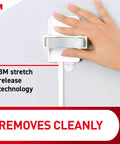 Hand demonstrating Stick On Broom And Mop Holder Wall Mount Kit With 6 Hangers And 16 Adhesive Strips No Holes No Tools