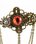 Epic Unisex Steampunk Hair Clip With Spinning Gears And Creepy Devil Eye Brooch For Halloween Costumes Or Gothic Daily Style Antique Gold Metal Alloy Jewelry Accessory featuring red eye detail and chain.