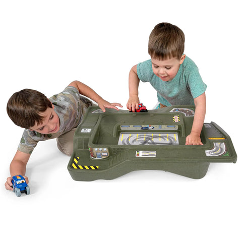 Children playing with Monster City Extreme Wheels Race Track Table For Kids, Portable Two Sided Play Table, green cityscape surface