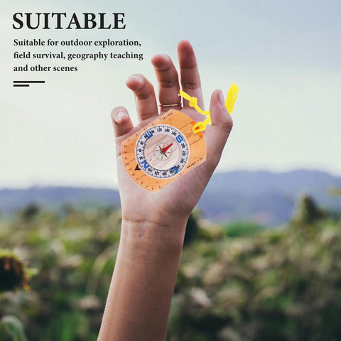 Holding Top Notch High Precision Survival Hiking Compass With Bright Orange Lanyard against a blurred outdoor background