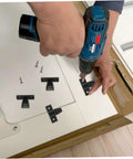 Person installing Straight Fire Quality Push On Fittings 10 Piece Quick Snap Connectors for cabinet with a drill.