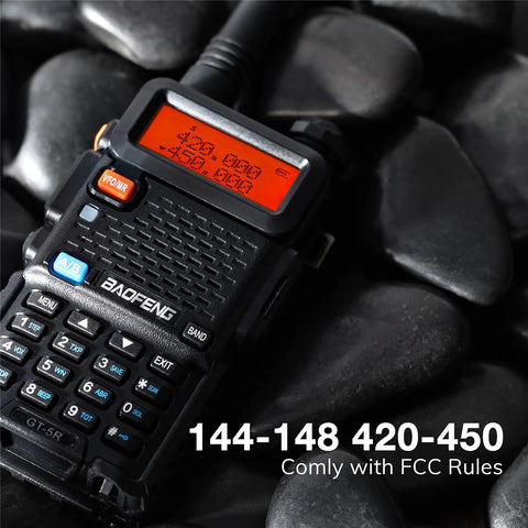Close-up of Six Pack GT5R Ham Radios Handheld Dual Band Two Way Radios FCC Compliant resting on black pebbles.