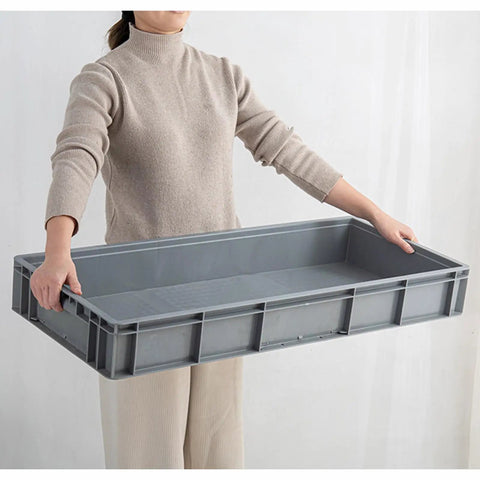 Movable Mop And Broom Holder In Stainless Steel With Drainage Basin being held, showing front view