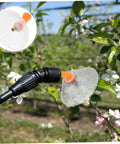 Drift Guard Spray Nozzles With Transparent Windproof Shield 2 Pack for agricultural sprayers, shown on garden hose spraying