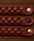 Braided Leather Drawer Pulls In Cognac Finish, 2 Pack, Measures 7-7/8 Inches Long By 1 Inch Wide, shown on wooden surface