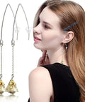 Woman wearing dangle earrings with hypoallergenic V shaped wires, part of the 40Pcs Stainless Steel Earring Hooks Kit.