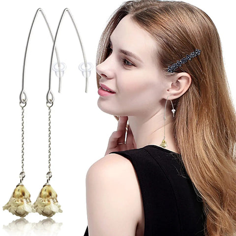 Woman wearing dangle earrings with hypoallergenic V shaped wires, part of the 40Pcs Stainless Steel Earring Hooks Kit.
