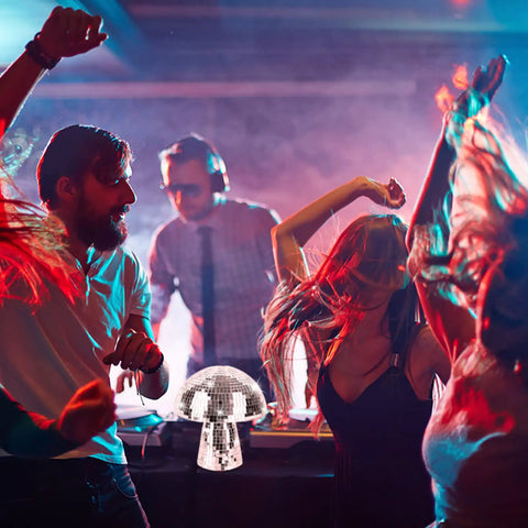 Mushroom Disco Ball Set Of Four, Silver Mirror Glitter Balls enhancing stage lighting at dance party, 4 Inch, 6 Inch, 7 Inch sizes visible
