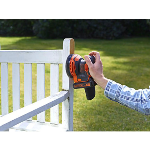 User operating Badass 18V Cordless Orbital Sander With Killer Dust Control on a wooden bench edge in sunlight.