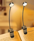 2 Pack Rechargeable Clip On Book Light With 10 LEDs illuminating an open book, showing flexible necks and clips for easy attachment