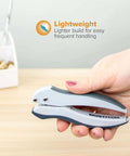 Hand holding lightweight gray and blue stapler on desk, ideal for frequent use and easy handling in home office. Pack Of 5 EZ Squeeze One-Hole Punch Set With 10 Sheet Capacity, Lightweight Gray Blue Desk Side Workhorse, No Jam Tech, Ergonomic Grip, Easy Clean Chip Tray, Handle Lock For Storage, Ideal For Home Office.