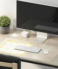 Clear 14 x 24 Inch Table Cover Protector Waterproof 2mm Thick Vinyl Desk Mat on a home office desk with monitor and plant