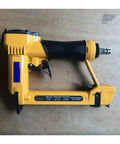 Professional Pneumatic Nail Gun Compatible With 7116 Staples And Air Compressor For Upholstery and Carpentry Tasks on wooden surface.