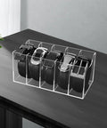 Upgrade Your Drawer Storage Vibe Today With This Sturdy Clear Acrylic Belt Organizer Designed With Five Flexible Foldable Sections To Store Ties And Belts on a wooden surface.
