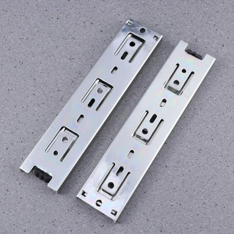 Two Pack Heavy Duty Steel Ball Bearing Drawer Slides With Buttery Smooth Gliding Action Built For Kitchen Storage Cabinets And Desk Pedestals Zero Fuss Telescopic Hardware Rails, steel tracks on gray background.