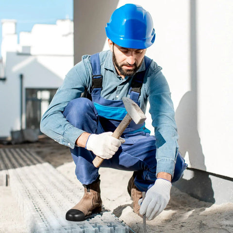 Worker on construction site wearing steel toe cap covers for shoes and work boots, tough as nails metatarsal protectors