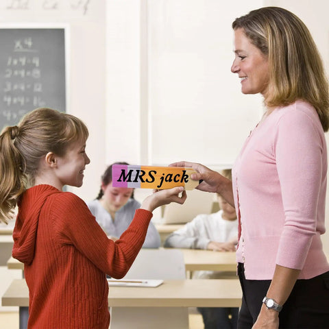 Teacher receiving Eight Pieces Personalized Pencil Name Plate Set With Blank Wooden Desk Signs from student in classroom