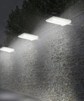 46 LED Solar Outdoor Lights With Mounting Pole 4 Modes Motion Sensor Wall Light illuminating stone wall at night
