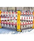 Heavy Duty Expandable Traffic Fence Slick Rolling Pedestrian Safety Barrier with red and white stripes in a park setting.