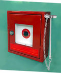 Emergency Stainless Steel Fire Alarm Button Hammer For Industrial Use next to red call point box on green wall