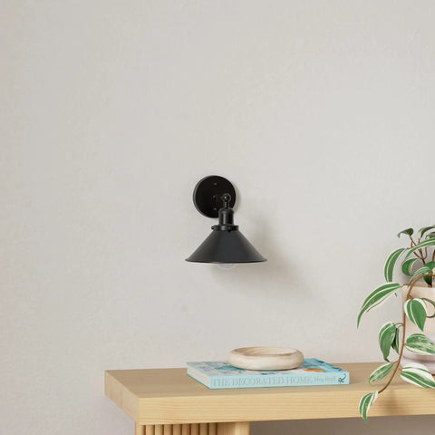Two Pack Black Swing Arm Wall Sconces With Remote Control Cordless Battery Powered LED Wall Lamps on white wall above shelf.