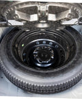 Spare Tire Bolt Hold Down Clamp For Secure Wheel Retention, Grab-And-Go Install, in trunk of vehicle with mounted tire