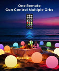 Beach setting with multiple Huge 16 Inch RGB Night Light Balls With Remote Control Color Changing for mood lighting at night.