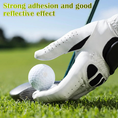 Golfer placing ball with Golf Ball Reflective Stickers For Tracking And Swing Analysis, 300 pcs on green grass with club.