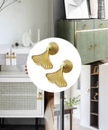 Six Piece Golden Ginkgo Leaf Cabinet Knobs displayed on various furniture, smooth drop pendant pull handle hardware for drawers.